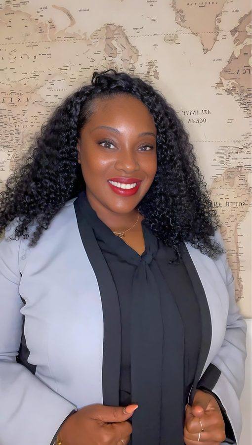 Antroinette Smith, Founder, Principal Event Strategist & Producer, photographed before a vintage world map