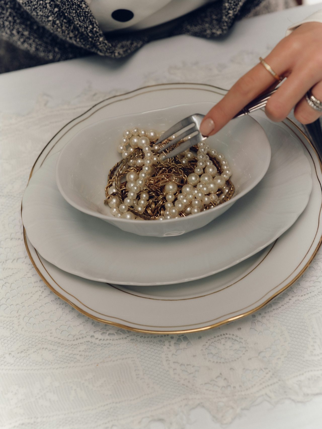 Gold necklace on scalloped plate
